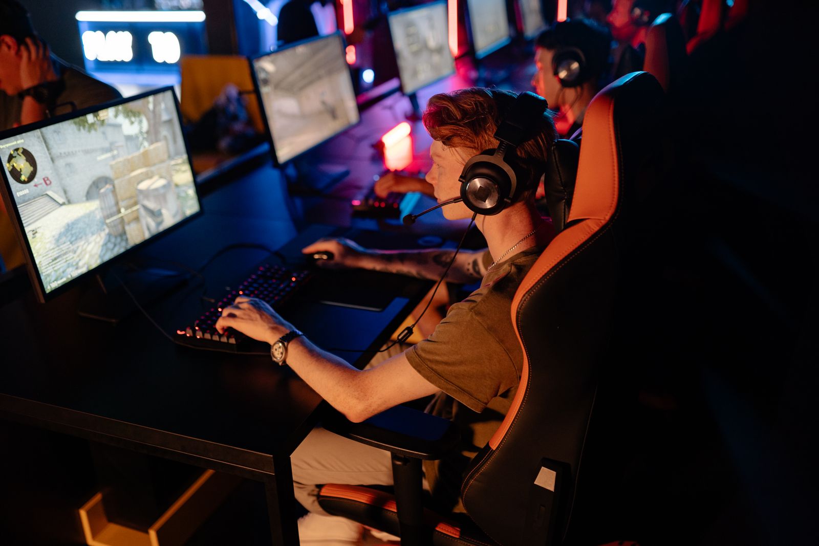 Competitive gamer at a custom PC setup during an esports match
